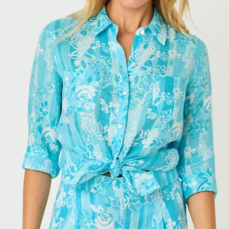 Woman wearing a blue floral dress with a white background