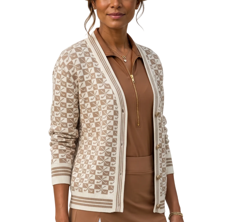 Woman wearing a patterned cardigan over a brown top and skirt with a beige hat.