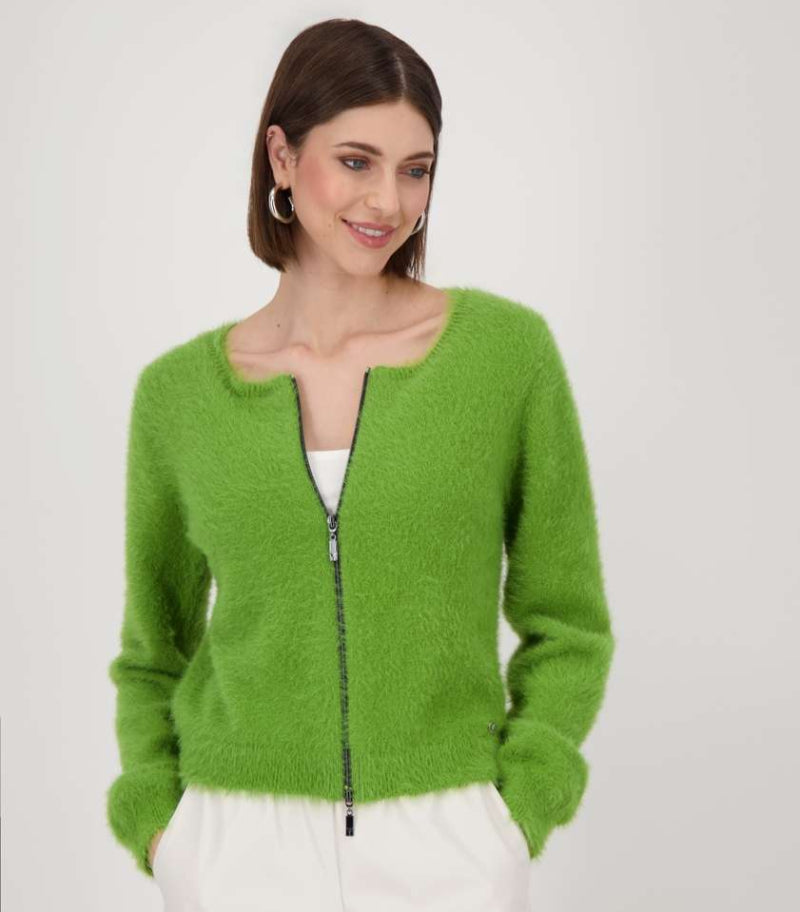 Woman wearing a green cardigan with a zipper on a white background
