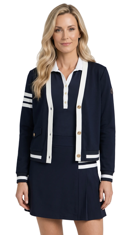 Woman wearing a navy and white outfit with a cardigan and skirt on a white background